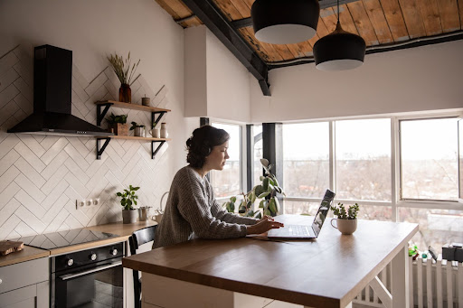 An image shows a woman working from home.